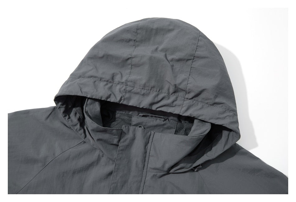 Close-up of the gray jacket's hood, mesh-lined neckline, and covered front closure.