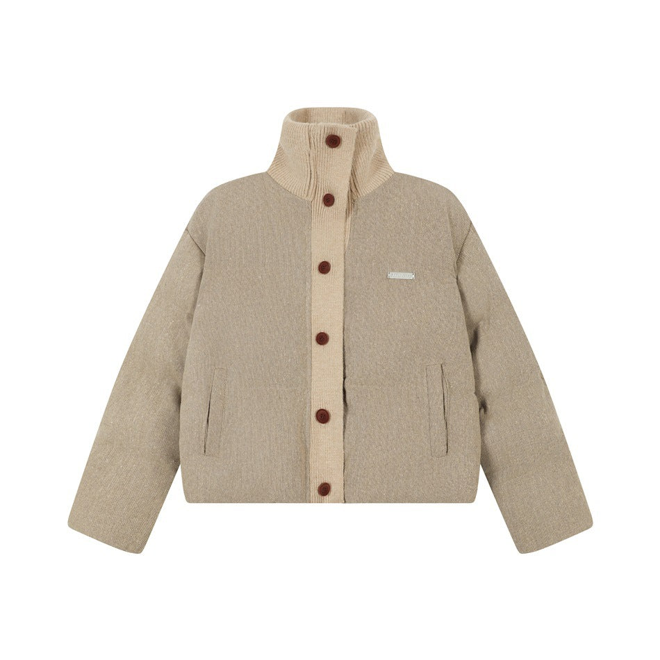 Tan cropped puffer jacket with beige knit stand collar, knit placket, red-brown buttons and slanted pockets, flat front view