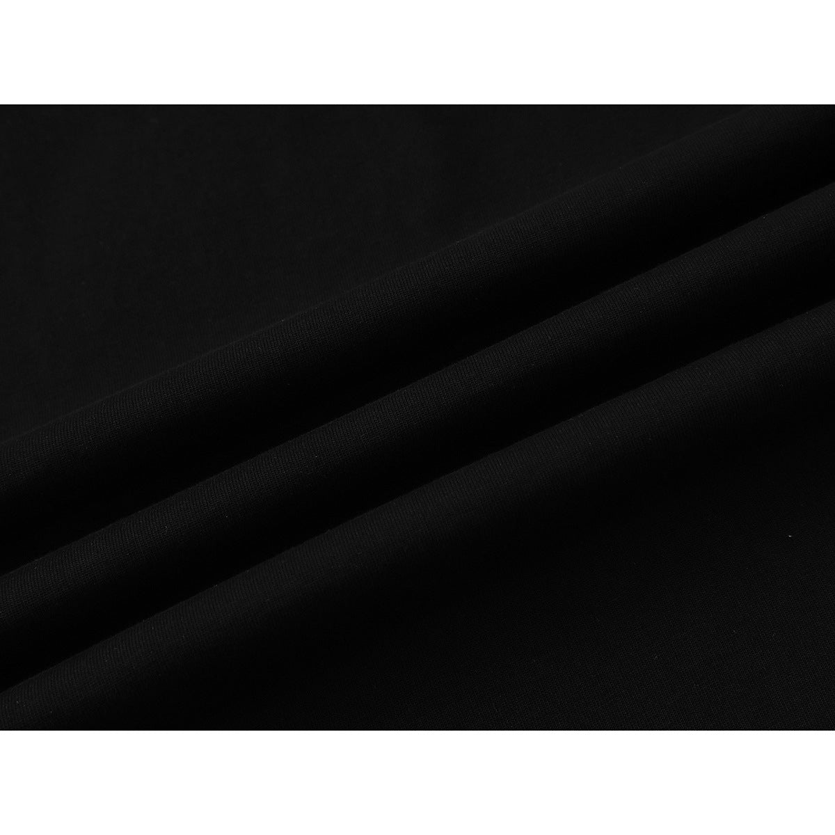 Close-up of black fabric arranged in diagonal folds.