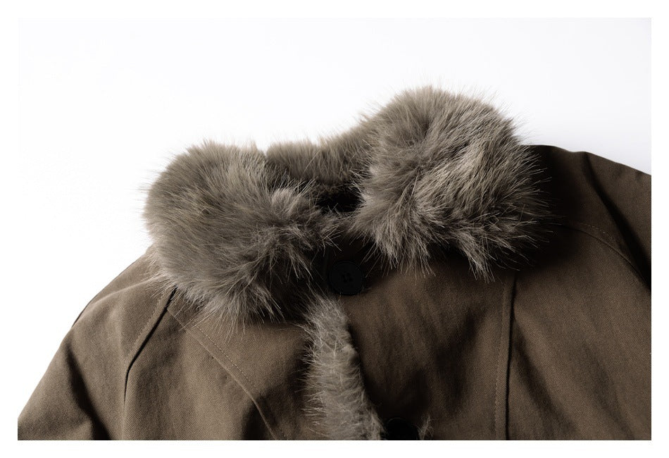Close-up of a dark brown jacket collar with gray-brown fur trim and a black button.