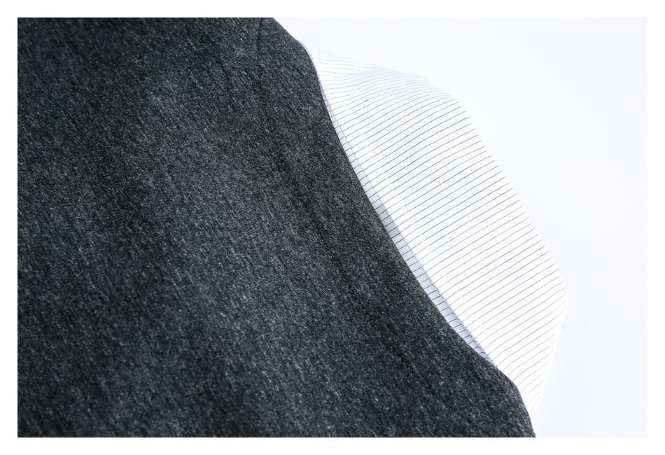 Close-up of a white fine-striped fabric edge beside charcoal heather fabric.