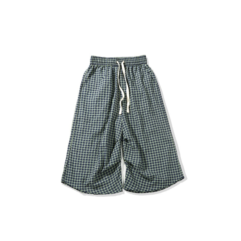 Navy and green plaid drawstring shorts with elastic waist, flat lay, wide legs