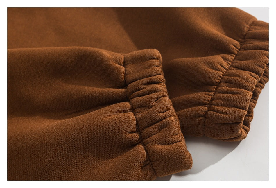 Close-up of gathered cuffs on a brown garment.