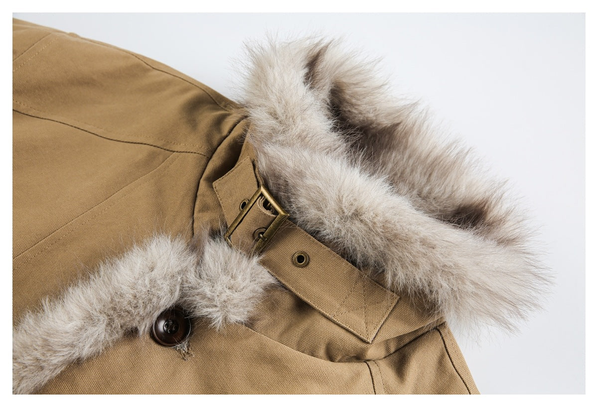Close-up of a tan jacket collar with fluffy light fur trim, a buckle tab, and a dark button.