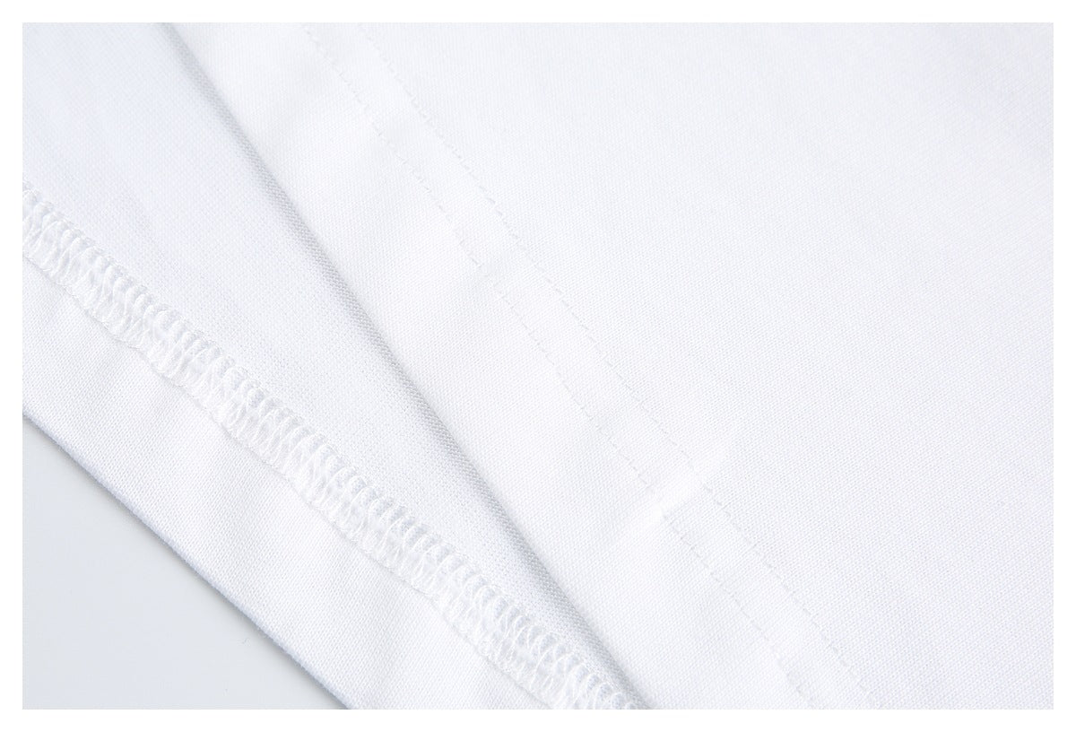 Close-up of stitching and an overlocked seam on white shirt fabric.