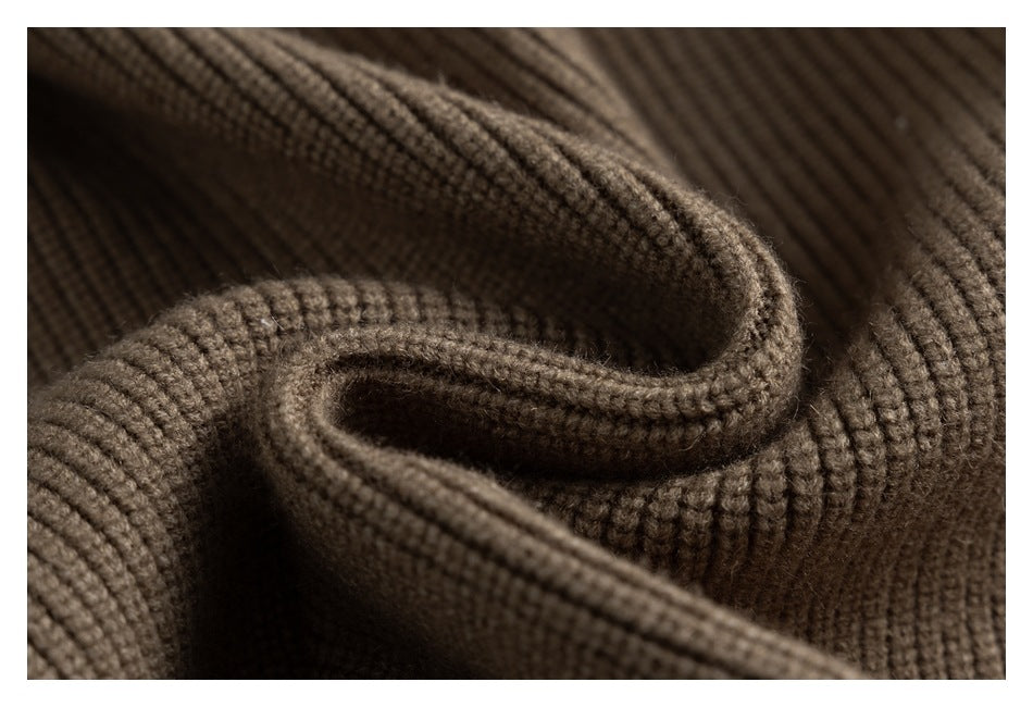 Close-up of brown ribbed knit fabric folded into soft curves.