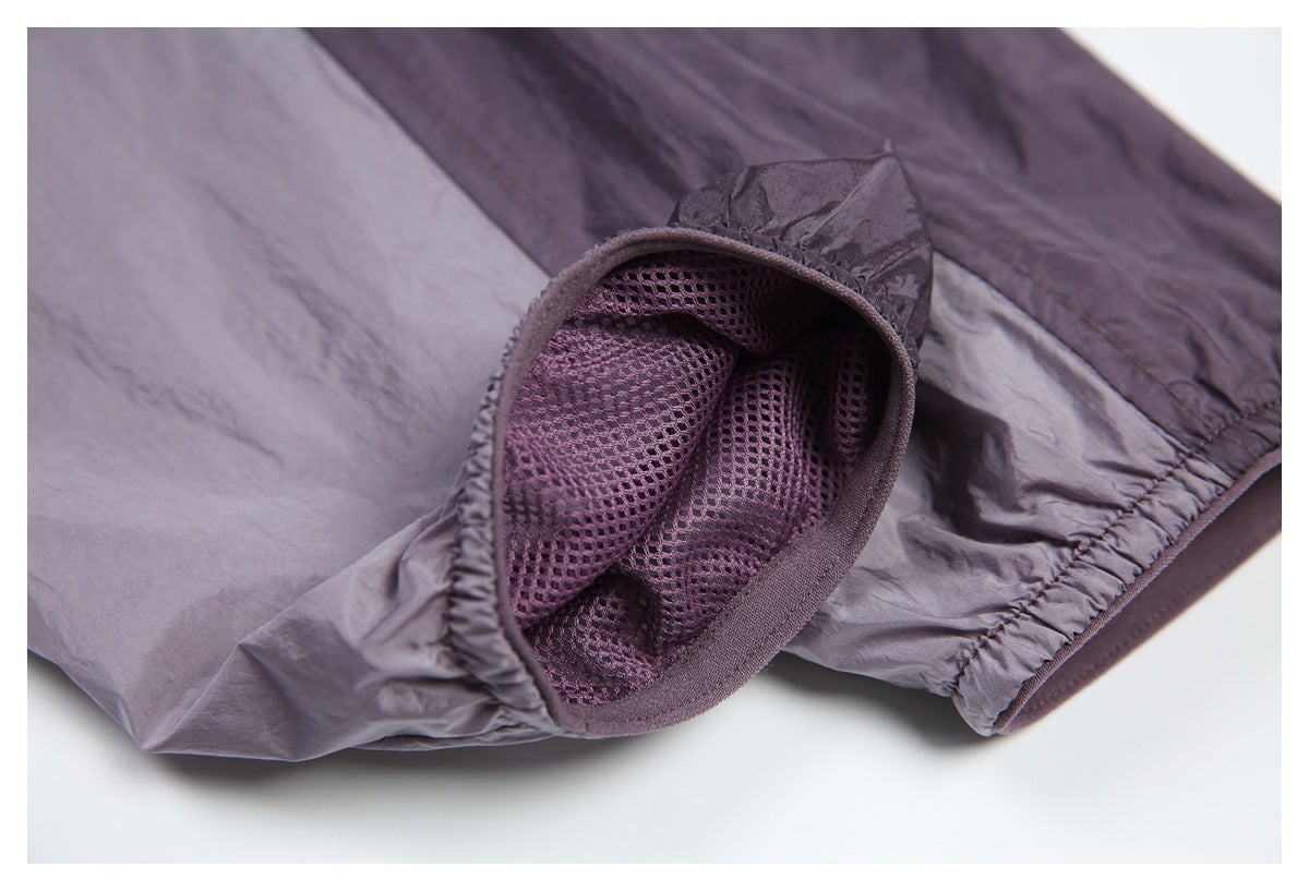 Close-up of a jacket cuff opened to show purple mesh lining and gathered elastic edging.