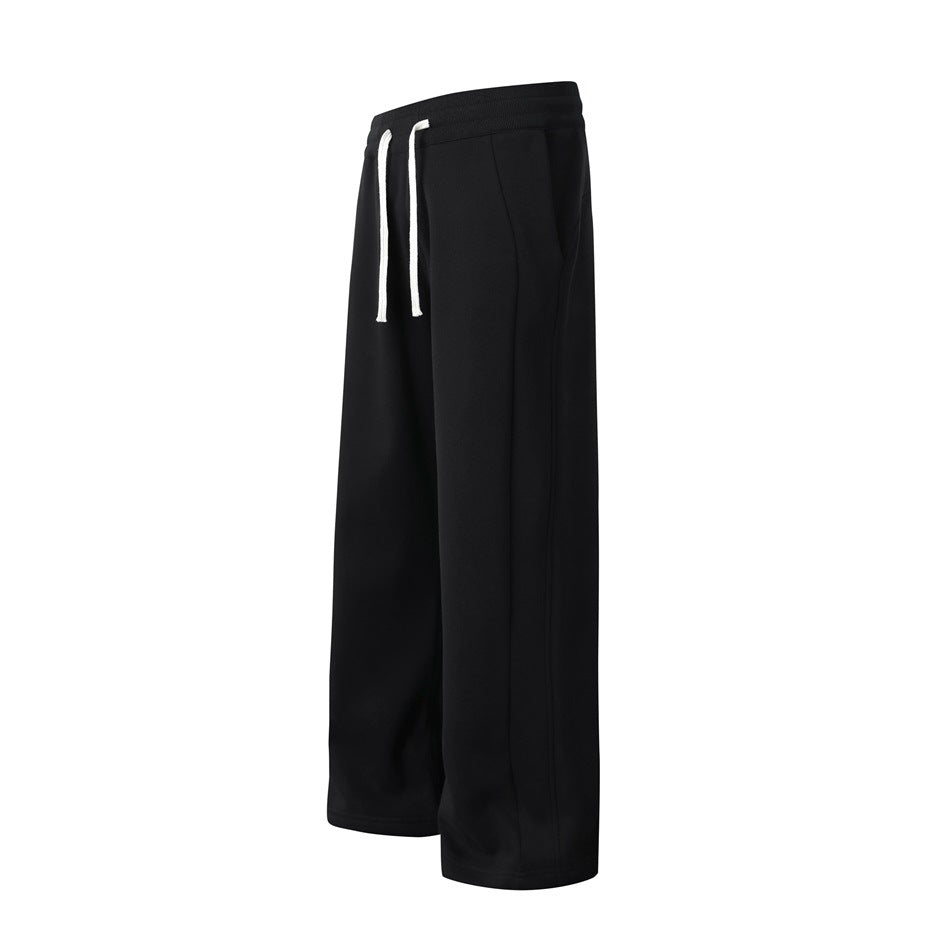 Black wide-leg pants shown at an angle, with an elastic waistband, white drawstrings, and side pockets.
