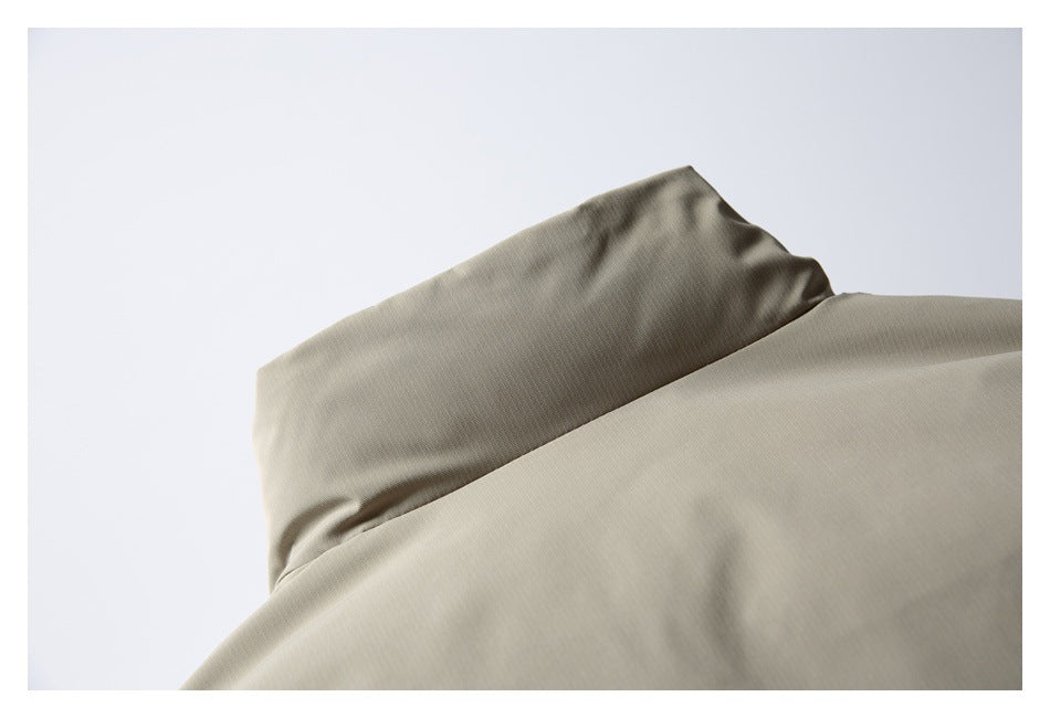 Close-up of a smooth taupe garment with a folded edge or collar.