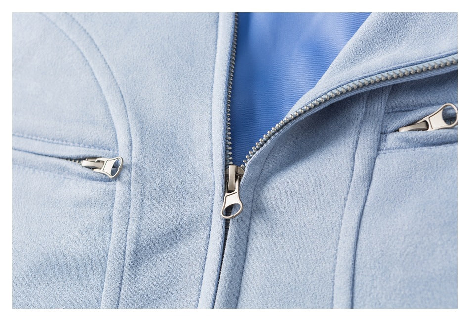 Close-up of a light blue jacket front with an open main zipper and two zip pockets.