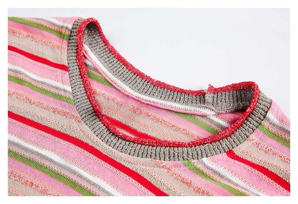 Close-up of a pink striped top's crew neckline with gray ribbed trim edged in red.