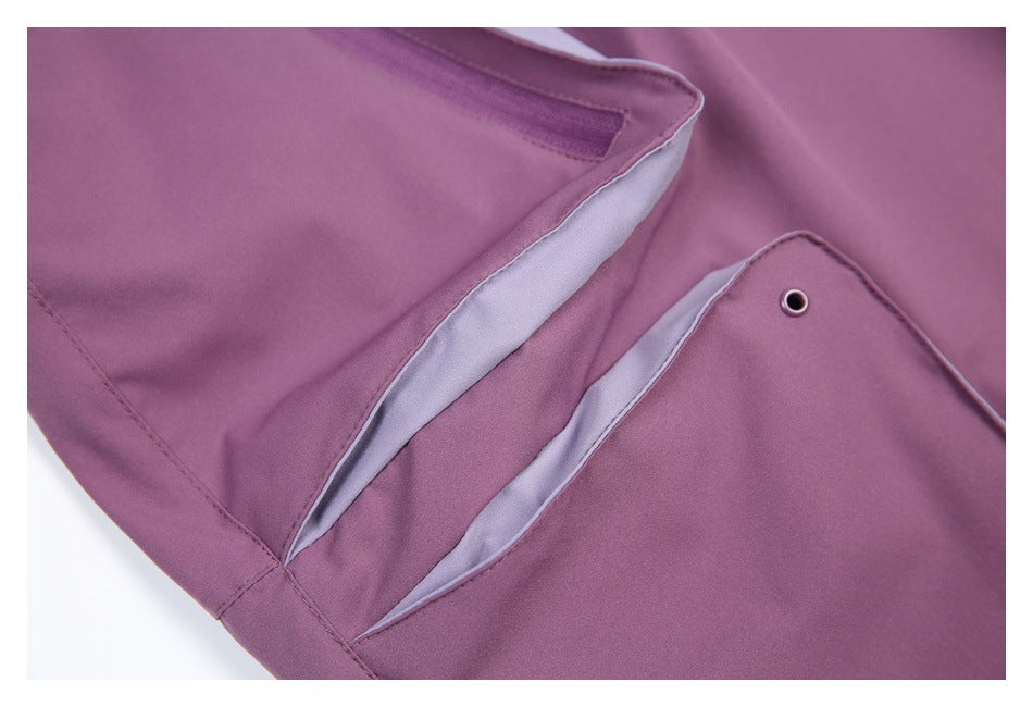 Close-up of mauve pants showing pale gray lining inside a flap pocket and a metal eyelet.