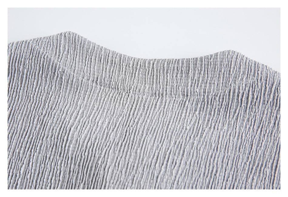 Close-up of the back neckline and collar seam on a light gray textured shirt.