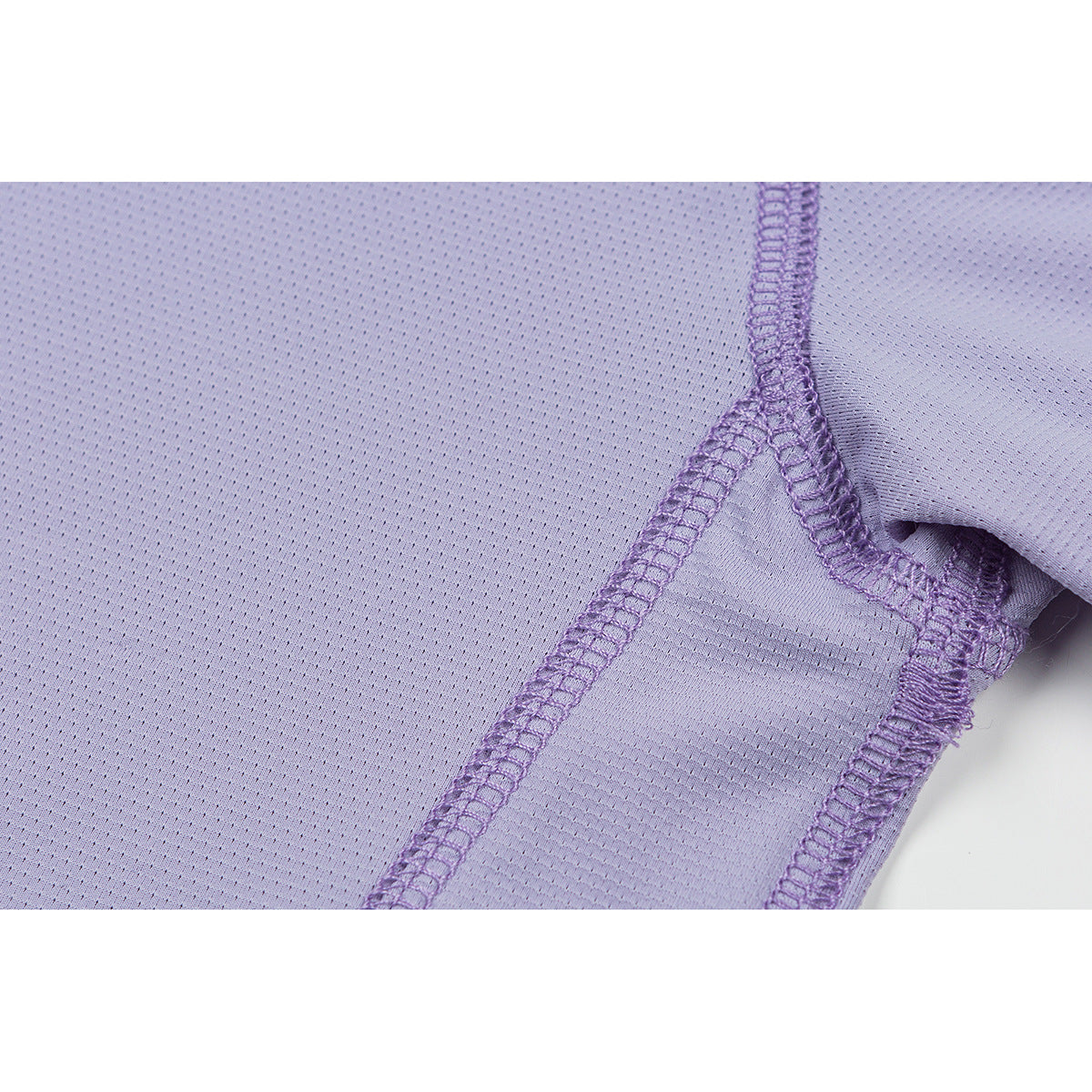 Close-up of lavender shirt fabric and overlocked seams at the sleeve and body junction.