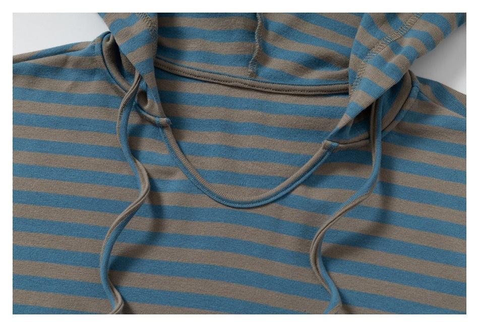 Close-up of the striped top's hood neckline and drawstrings, showing the stitching and stripe pattern.