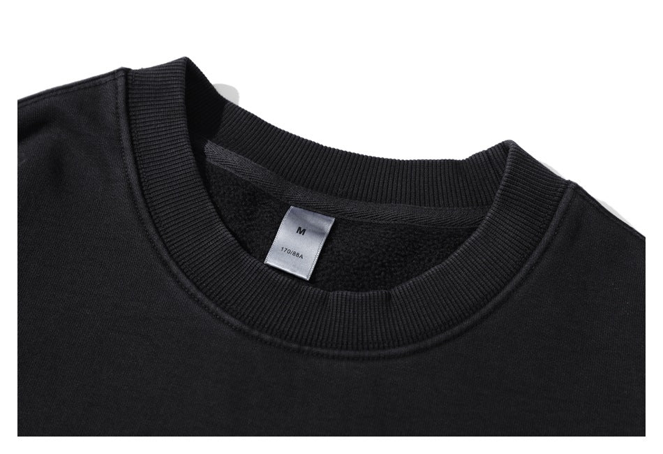 Close-up of the black sweatshirt's ribbed neckline and inner size label marked M and 170/88A.