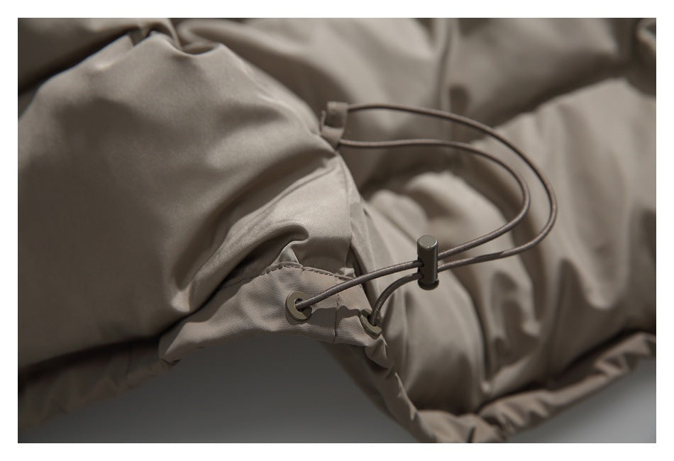 Close-up of a taupe jacket hem drawcord, metal eyelets and cord lock.