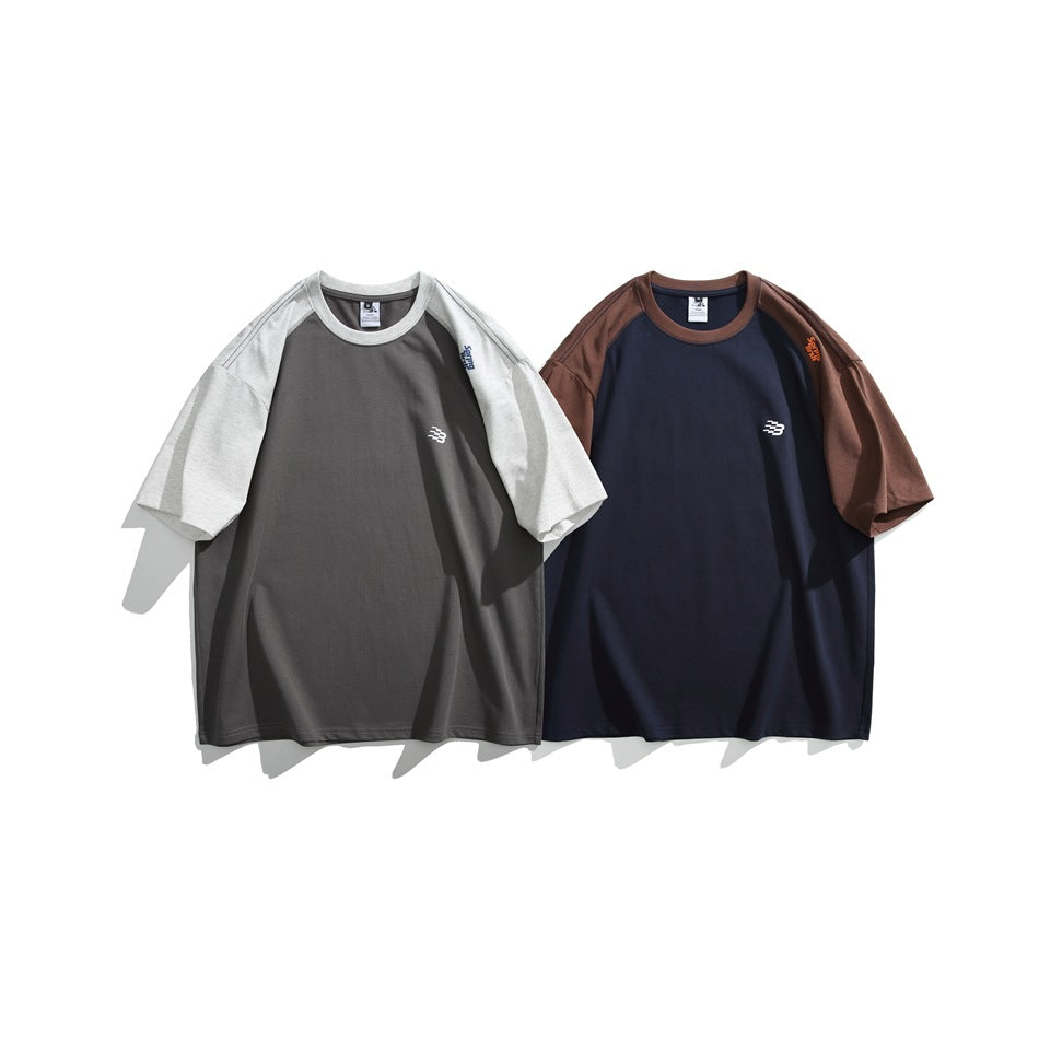 Two short-sleeve raglan T-shirts shown front-facing: charcoal with light gray sleeves, and navy with brown sleeves.