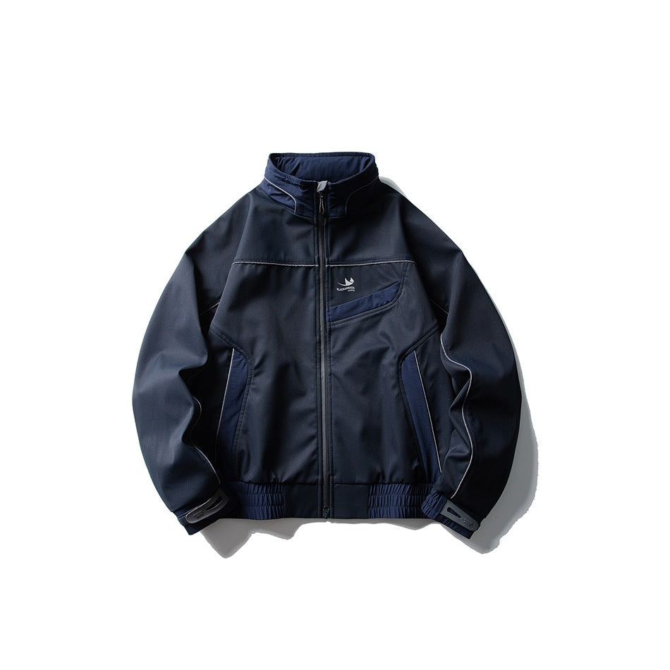 Navy blue stand-collar zip jacket with light gray piping, panel details and elastic hem, flat lay front