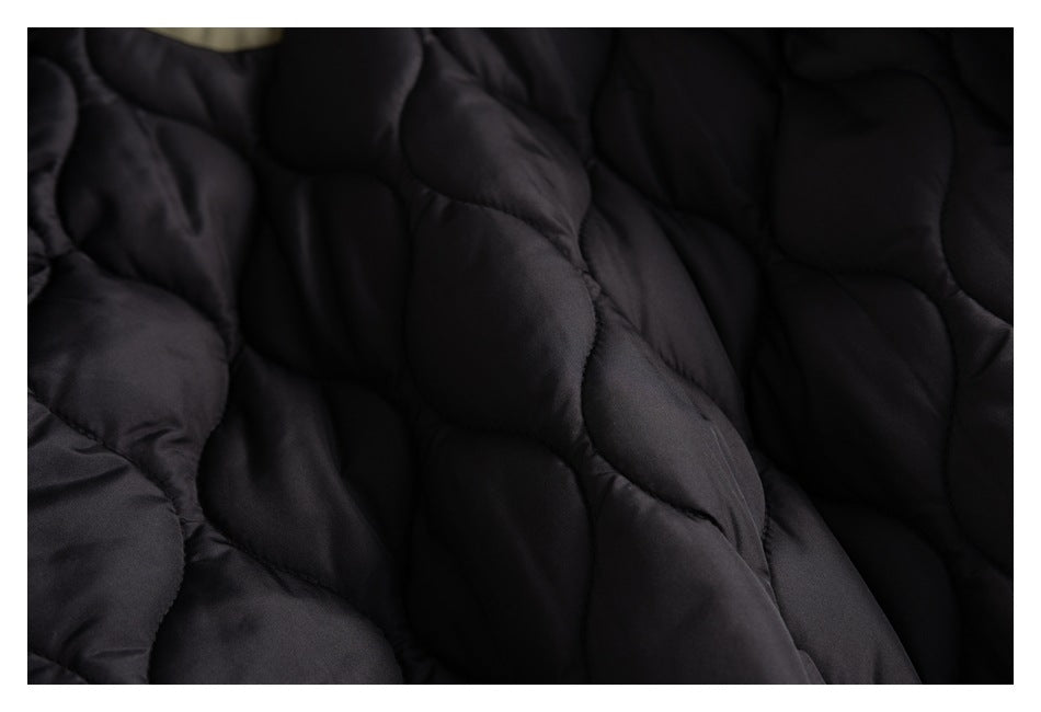 Close-up of the jacket's dark quilted lining with rounded stitched sections.