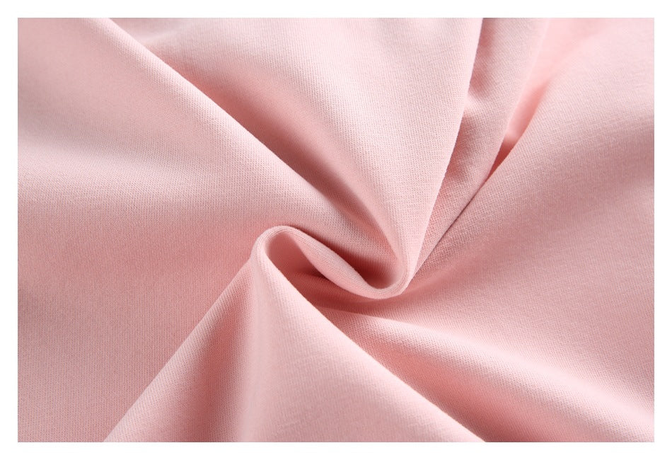 Close-up of pale pink fabric gathered into soft folds.