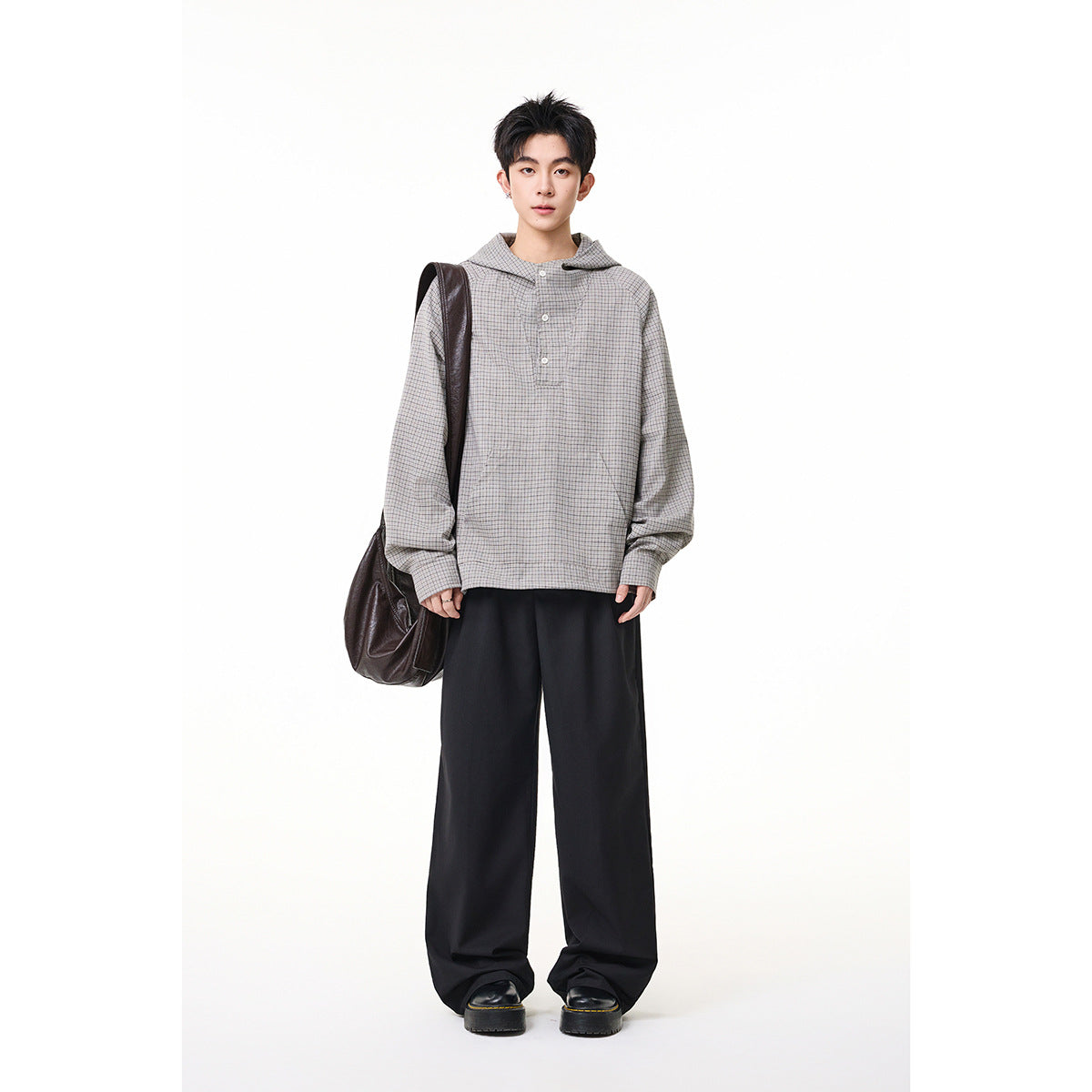 Full-length model wearing a gray micro-check hooded pullover with a button placket and black wide-leg trousers.