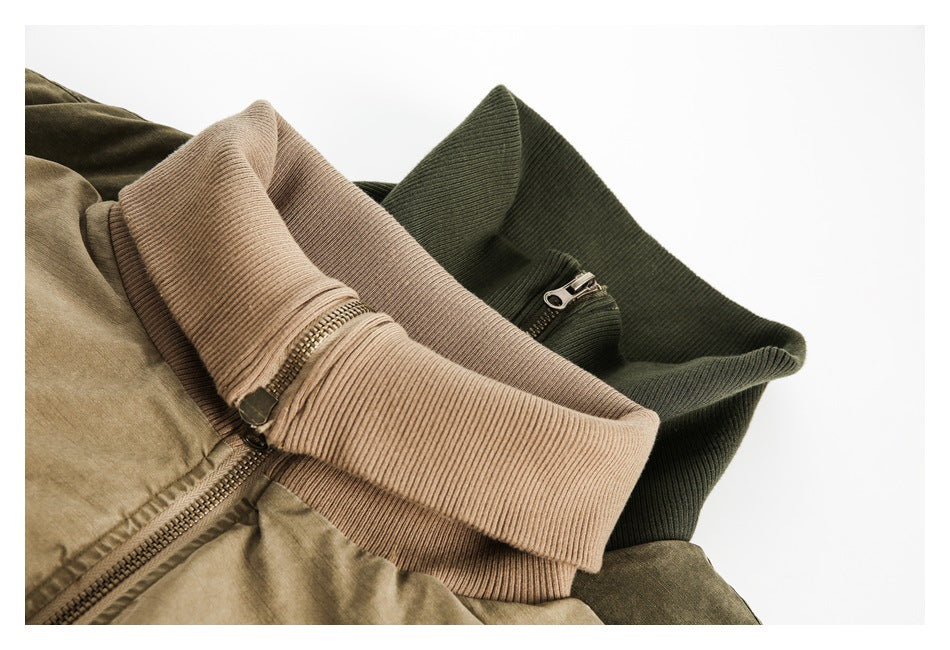 Close-up of tan and dark olive jackets with ribbed collars and short zippers.