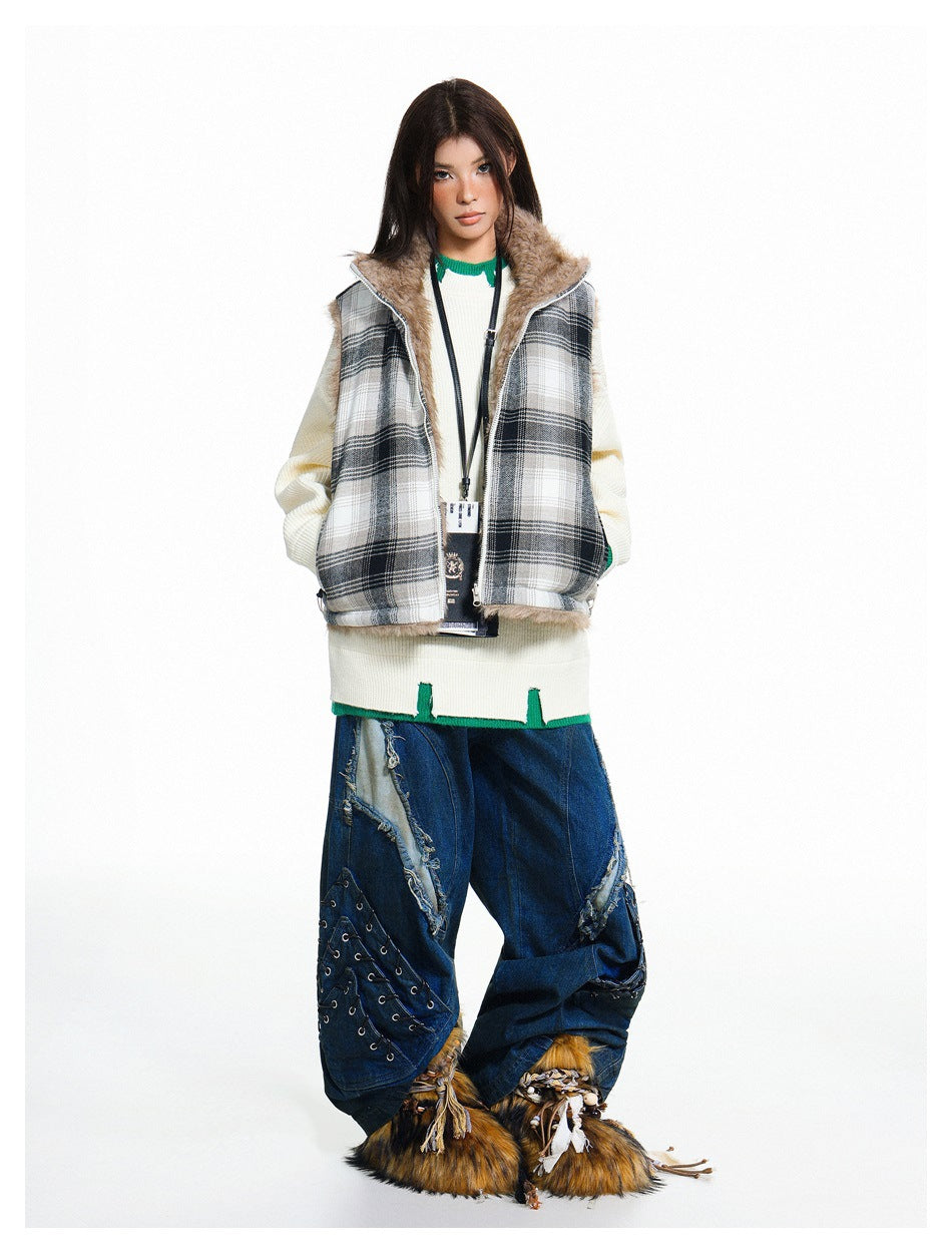 Full-length view of a model in the black plaid vest over a cream sweater with wide-leg jeans and fuzzy shoes