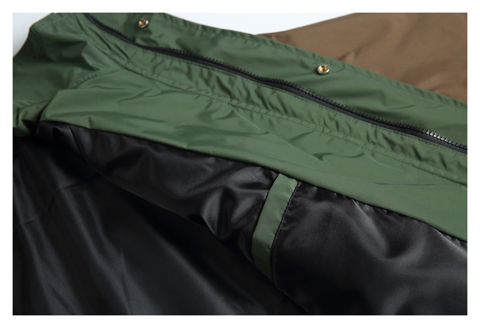 Close-up of a green jacket exterior with a black zipper and black lining.
