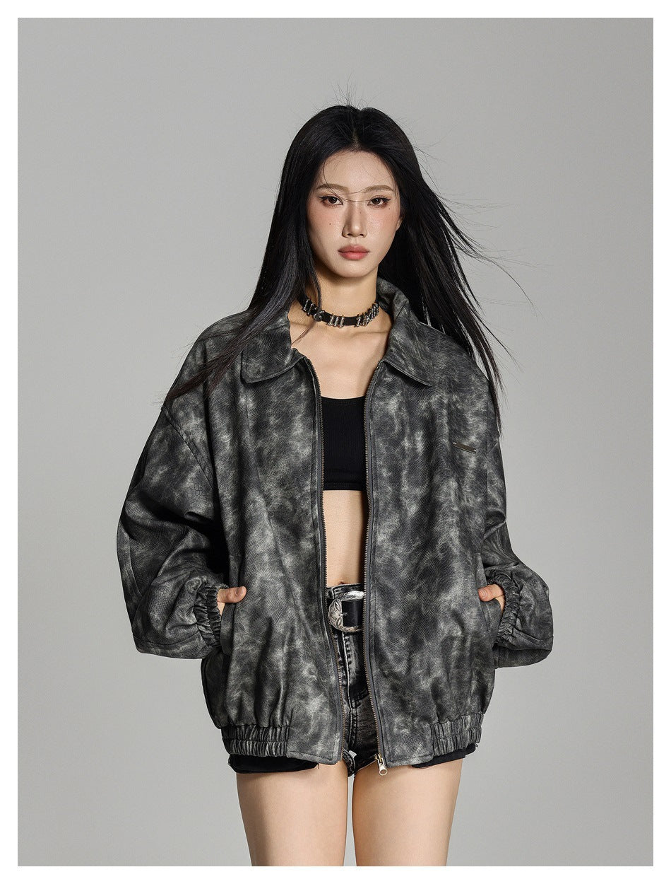Model wearing an open, oversized mottled charcoal-gray zip jacket with a wide collar and elastic cuffs and hem.