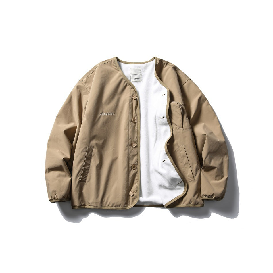 Tan button-front jacket laid flat and open, showing white lining, two lower pockets, and chest embroidery.
