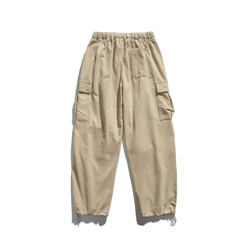 Beige cargo pants shown from the back, with an elastic waistband, rear patch pocket, side flap pockets, and drawcord hems.