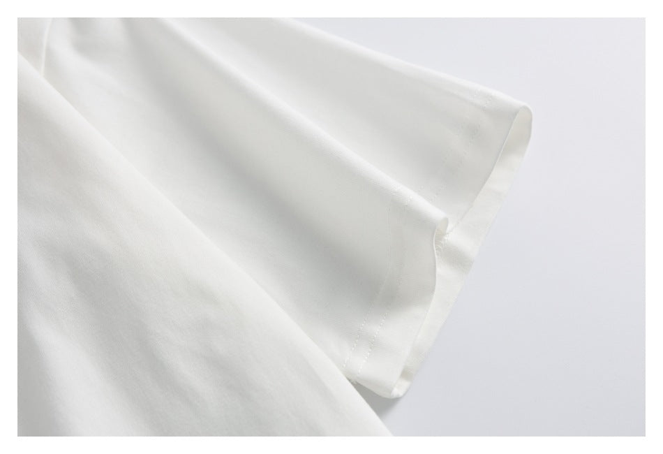 Close-up of the short sleeve and stitched cuff of a white T-shirt.