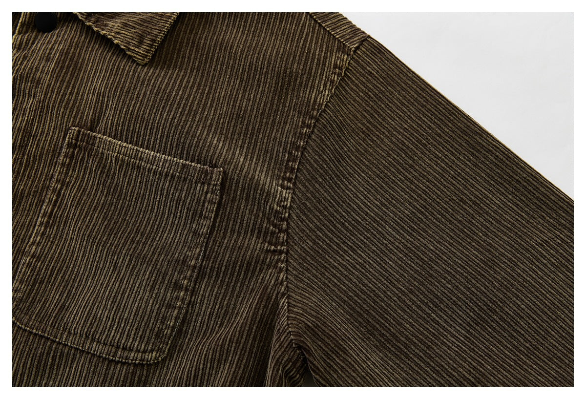Close-up of a brown corduroy jacket’s chest pocket, collar, and sleeve.