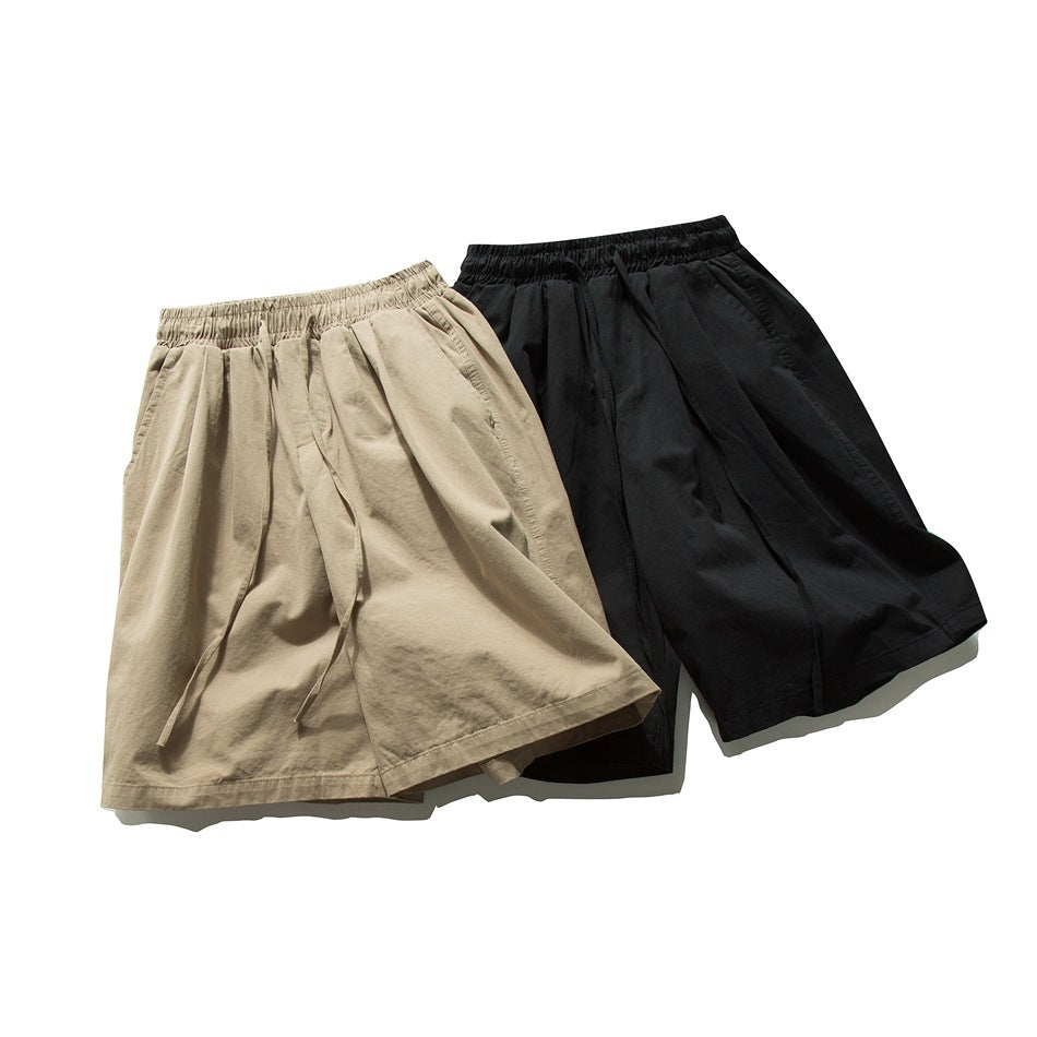 Tan and black shorts displayed together, with elastic waistbands, drawstrings, pleats and side pockets.