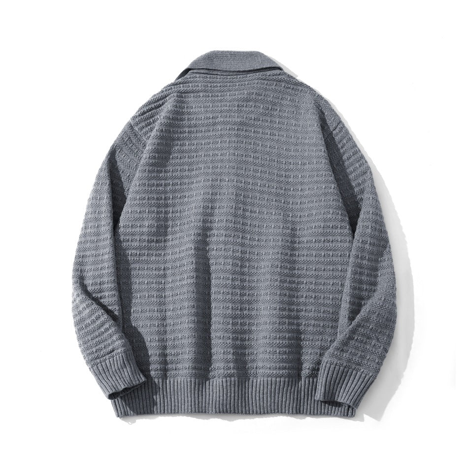 Back view of a gray textured cardigan with a wide collar, long sleeves, and ribbed cuffs and hem.
