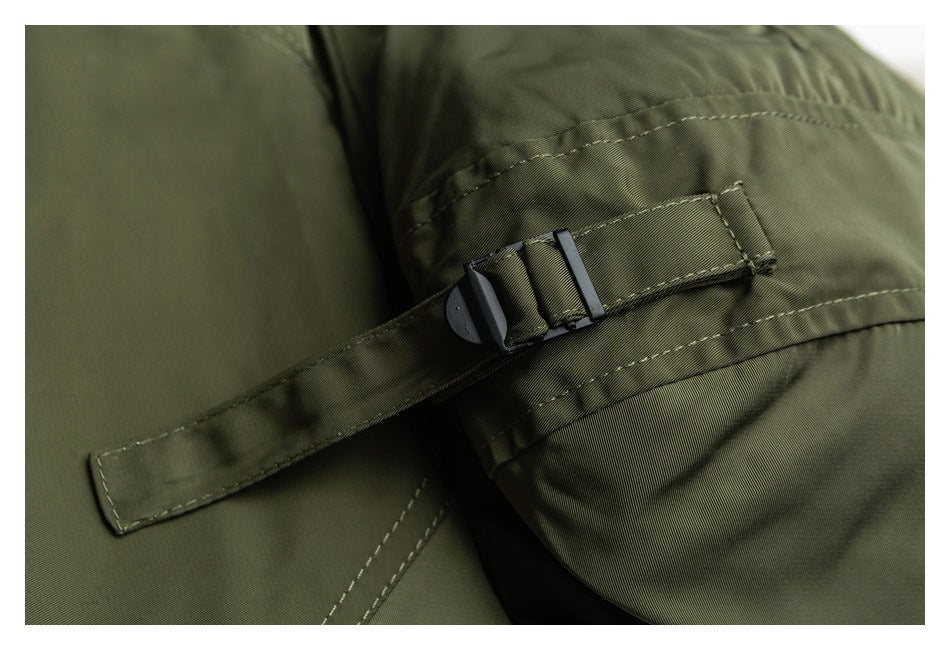 Close-up of an olive garment strap with a black buckle and visible stitching.