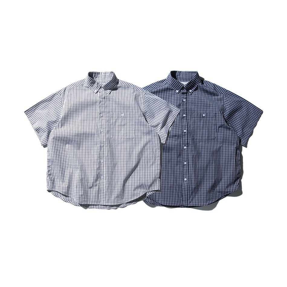 Two flat-lay short-sleeve checked button-up shirts, one light gray and one navy, each with a chest pocket.