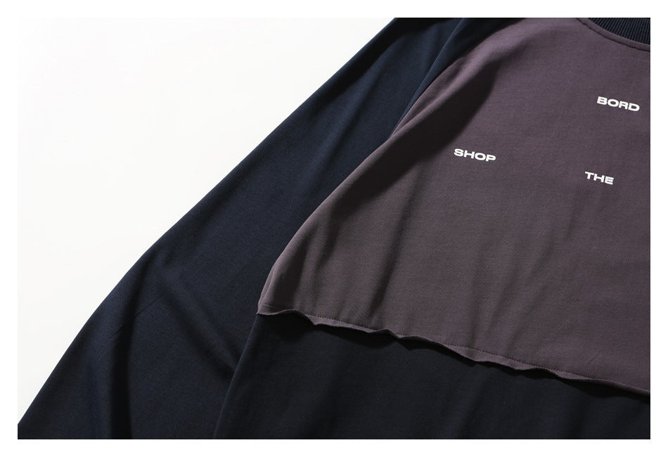 Close-up of the plum and navy shirt showing spaced white BORD, SHOP, and THE lettering on the front.