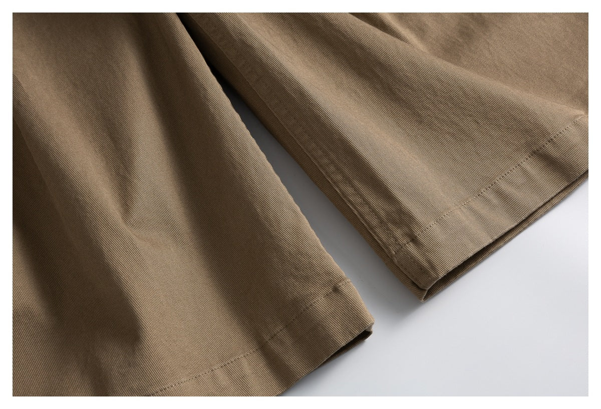 Close-up of the shorts' wide leg openings and stitched hems.