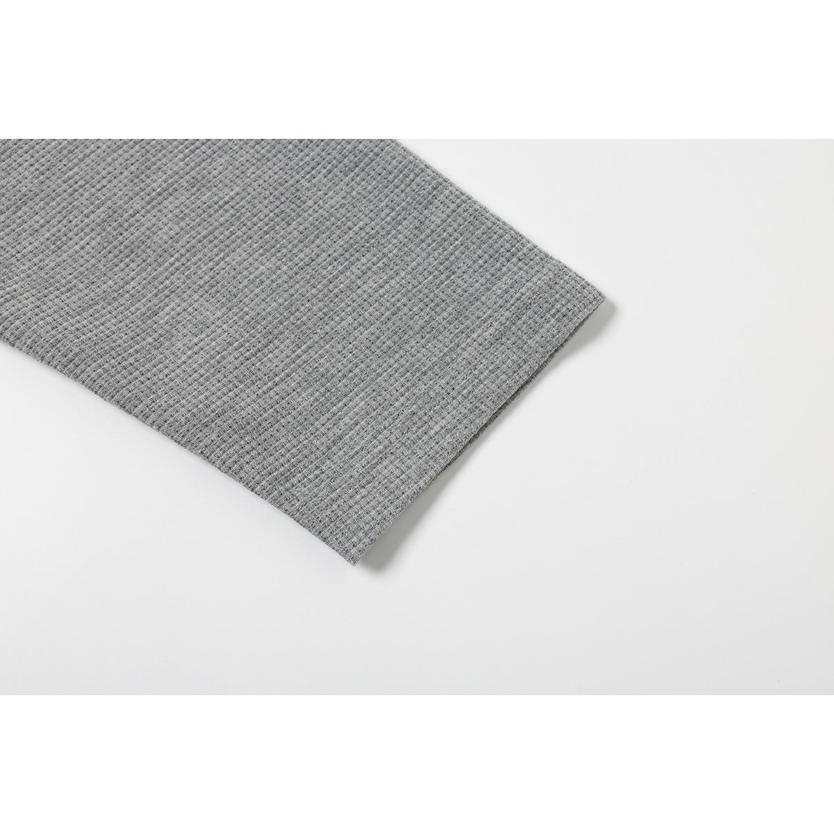 Close-up of the gray waffle-knit shirt sleeve and hem.
