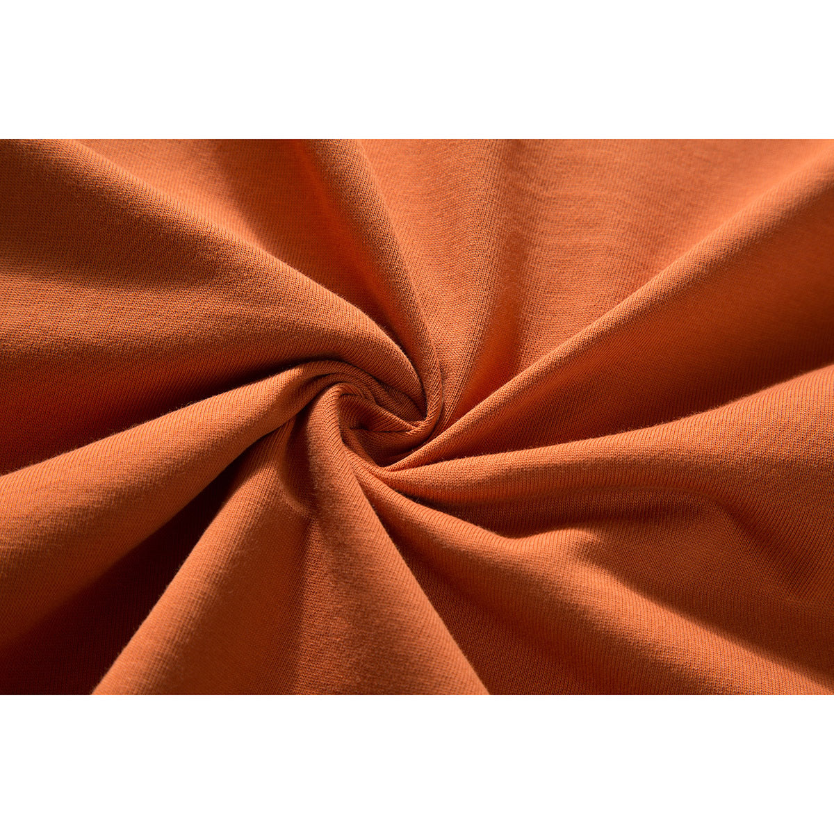 Close-up of orange fabric gathered into folds, showing its knit texture.