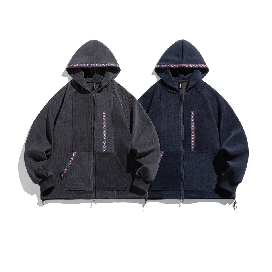 Front view of charcoal and navy zip-up hoodies with geometric hood trim, chest accents and large front pockets.