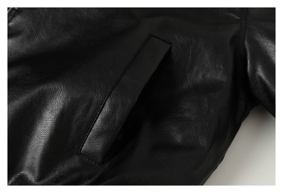 Close-up of a slanted welt pocket on the black jacket.