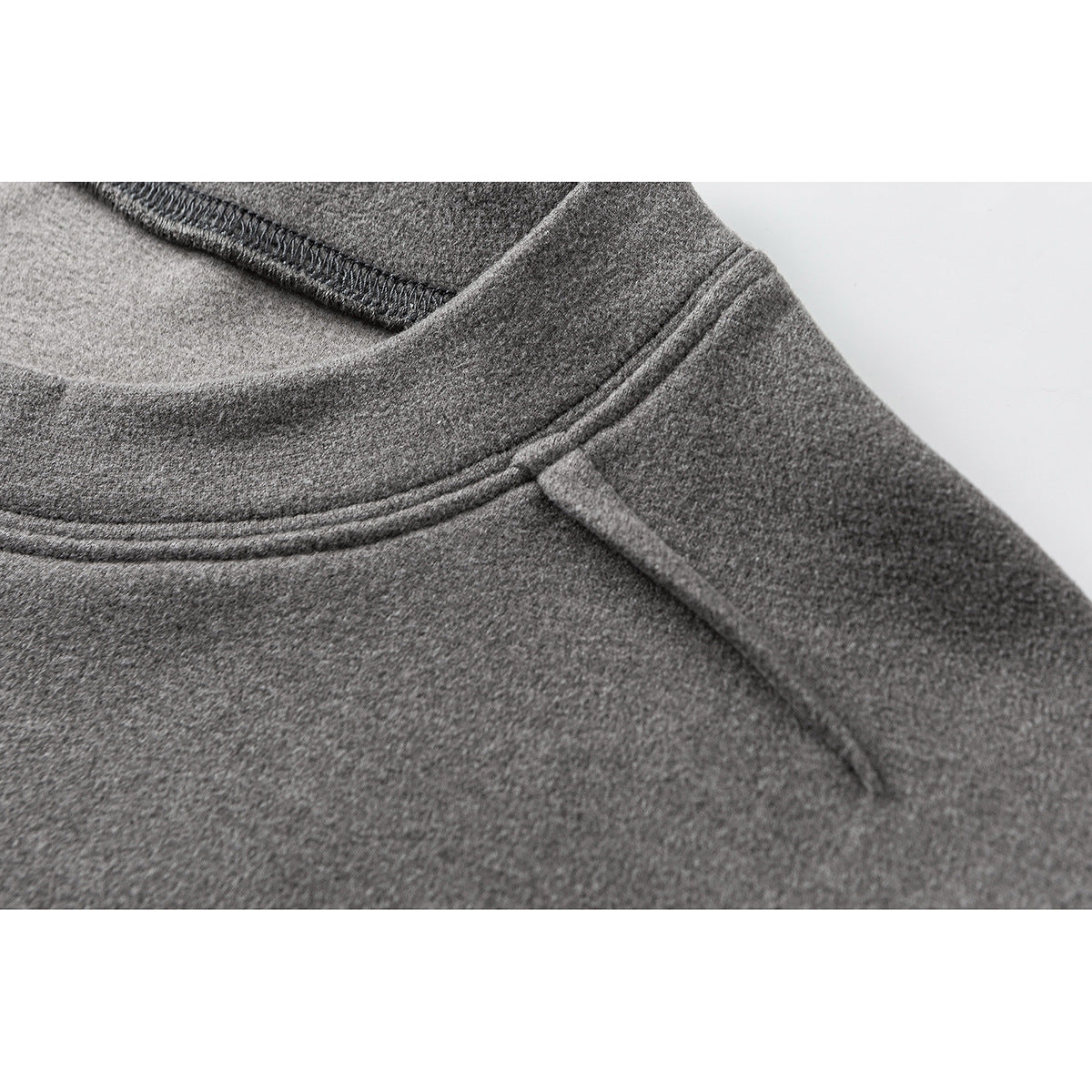 Close-up of a gray crewneck shirt showing the collar, shoulder seam, and stitching.