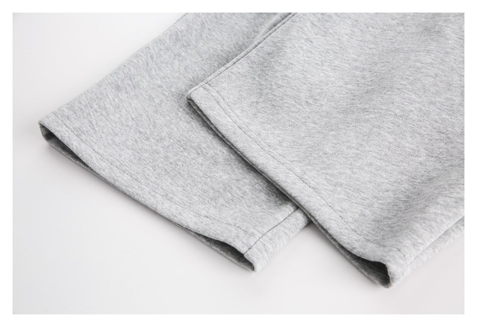 Close-up of the light gray heather sweatpants leg hems and stitching.
