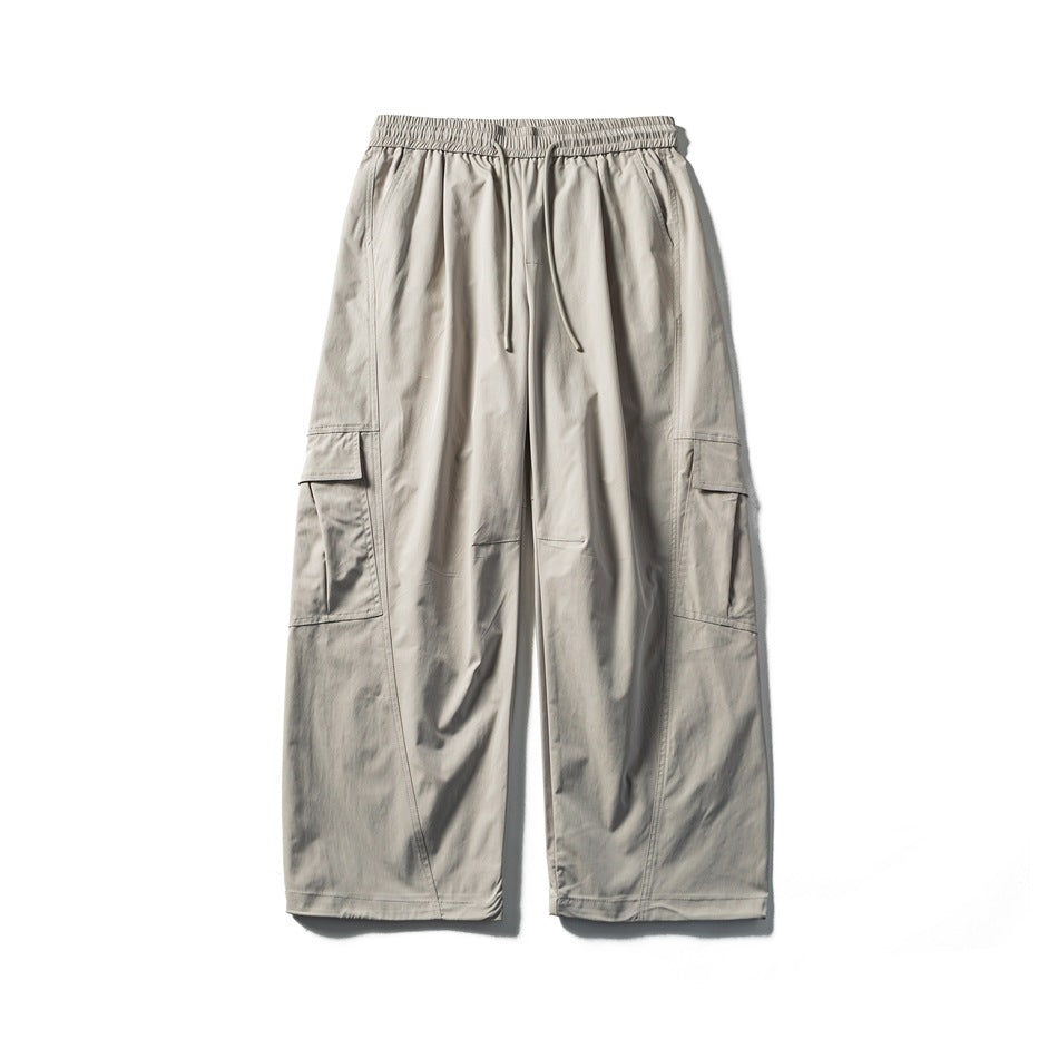 Off-white wide-leg cargo pants with drawstring elastic waist and side flap cargo pockets, flat lay front view