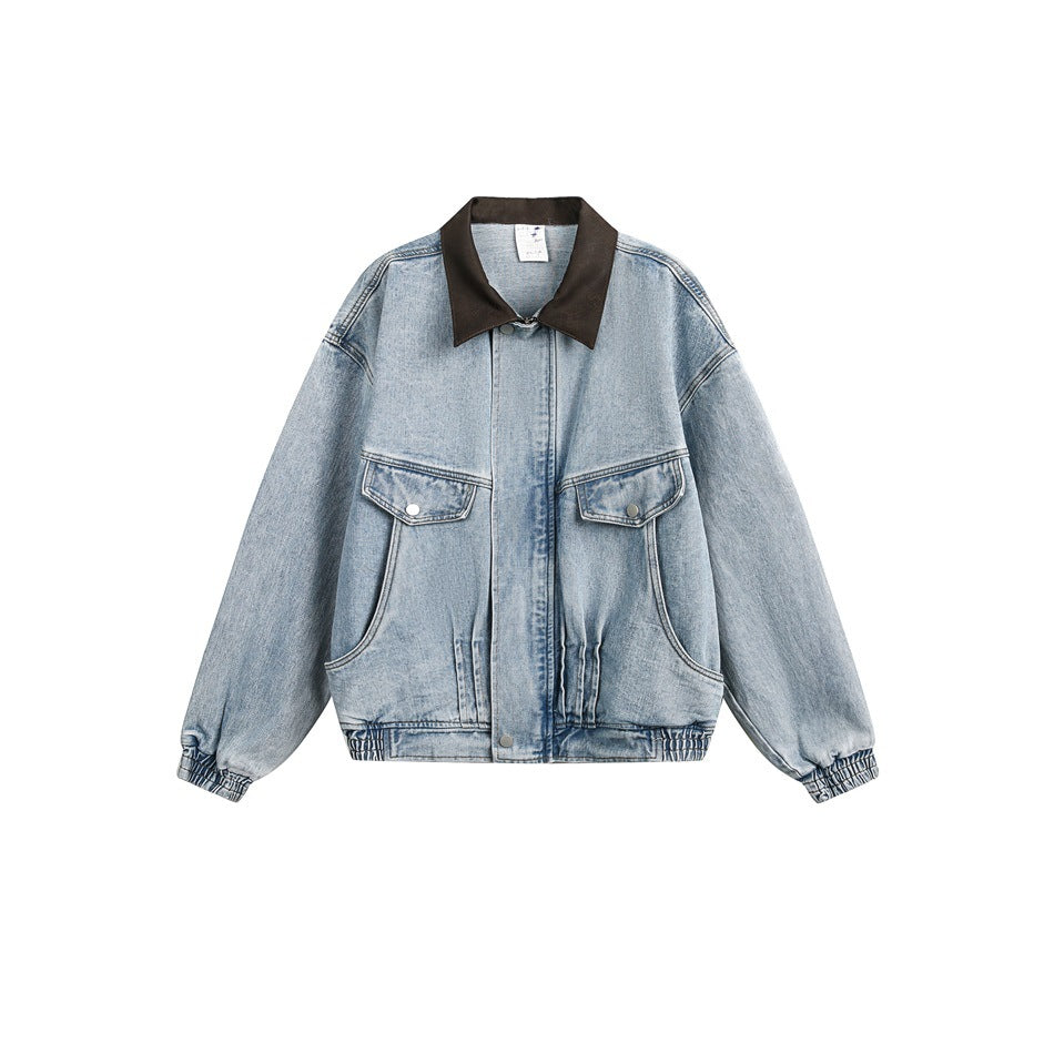 Light blue washed denim jacket with brown collar, chest flap pockets and elastic cuffs, flat front view