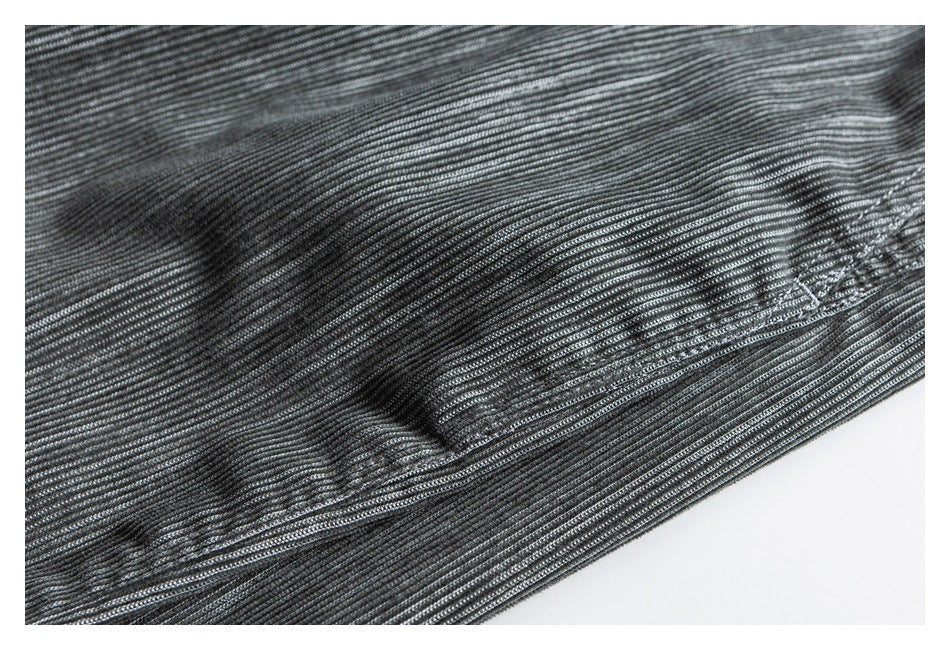 Close-up of the gray pants' fine raised stripe texture and a small stitched detail.