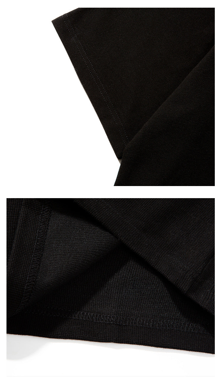 Close-up of the black T-shirt’s sleeve edge and interior seam stitching.
